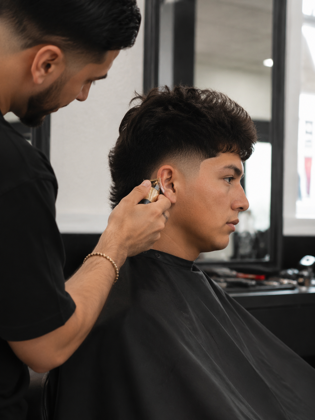 styling burst fade haircut at the barber