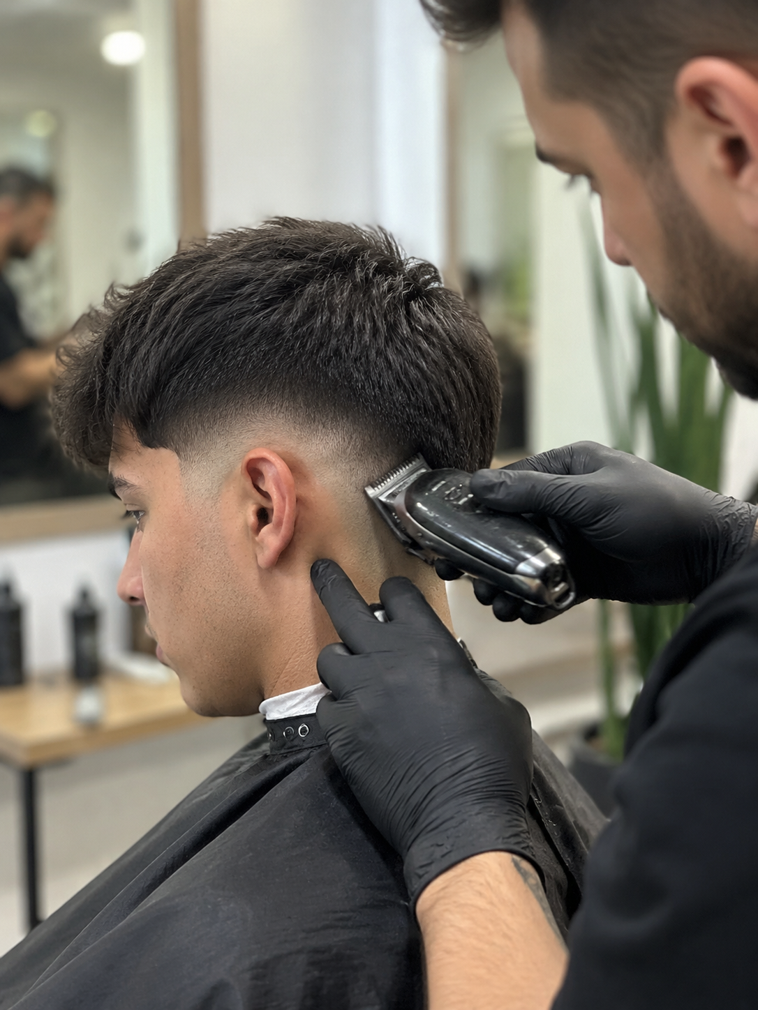 styling drop fade haircut at the barber